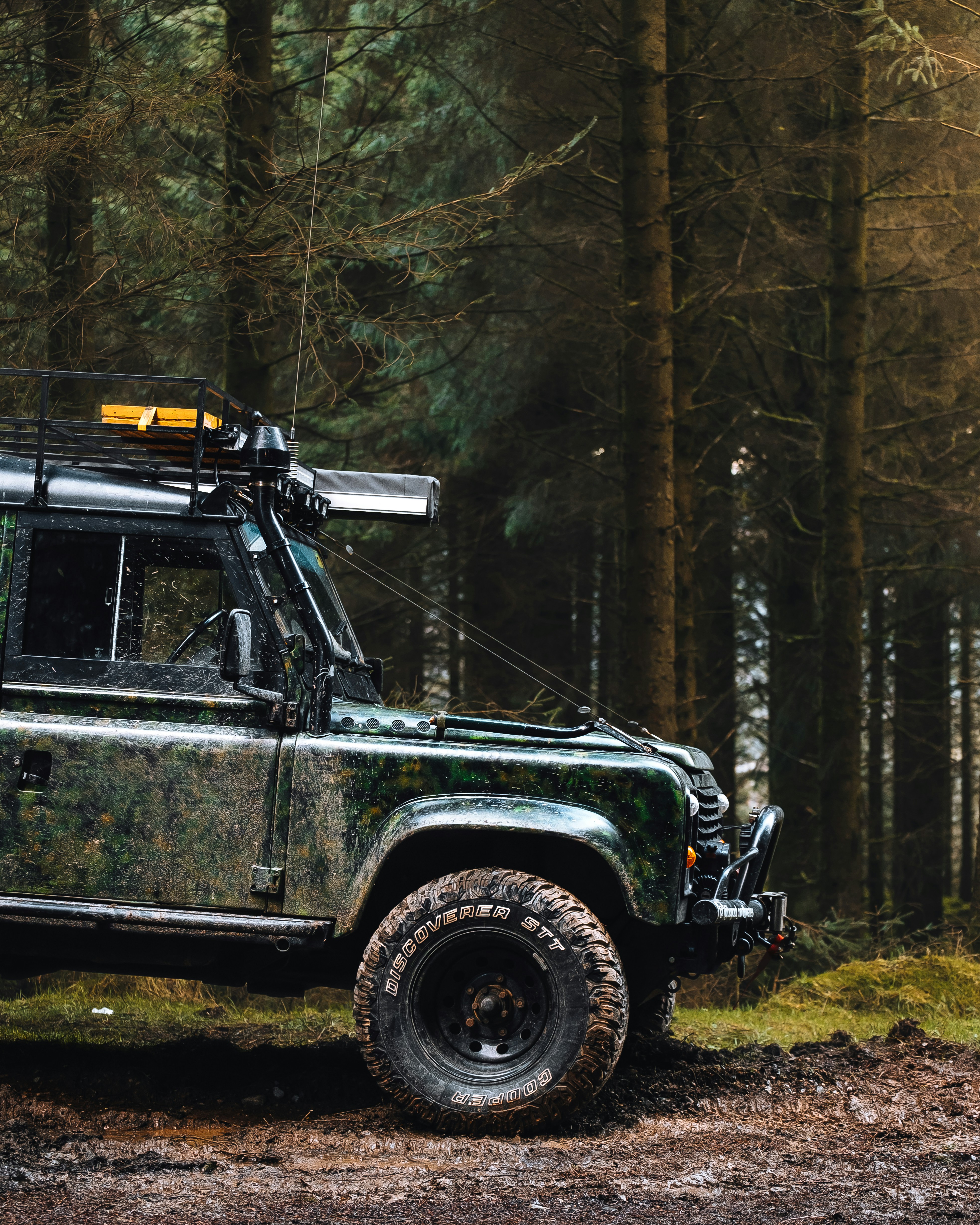 Land Rover Defender with Cooper tires in forest